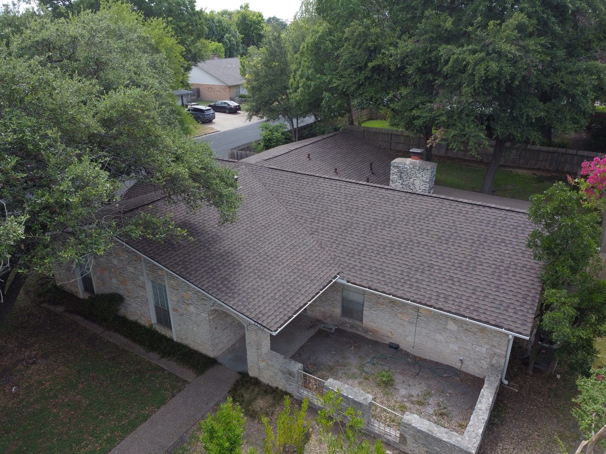 Aerial view of roofing crew installing new shingles