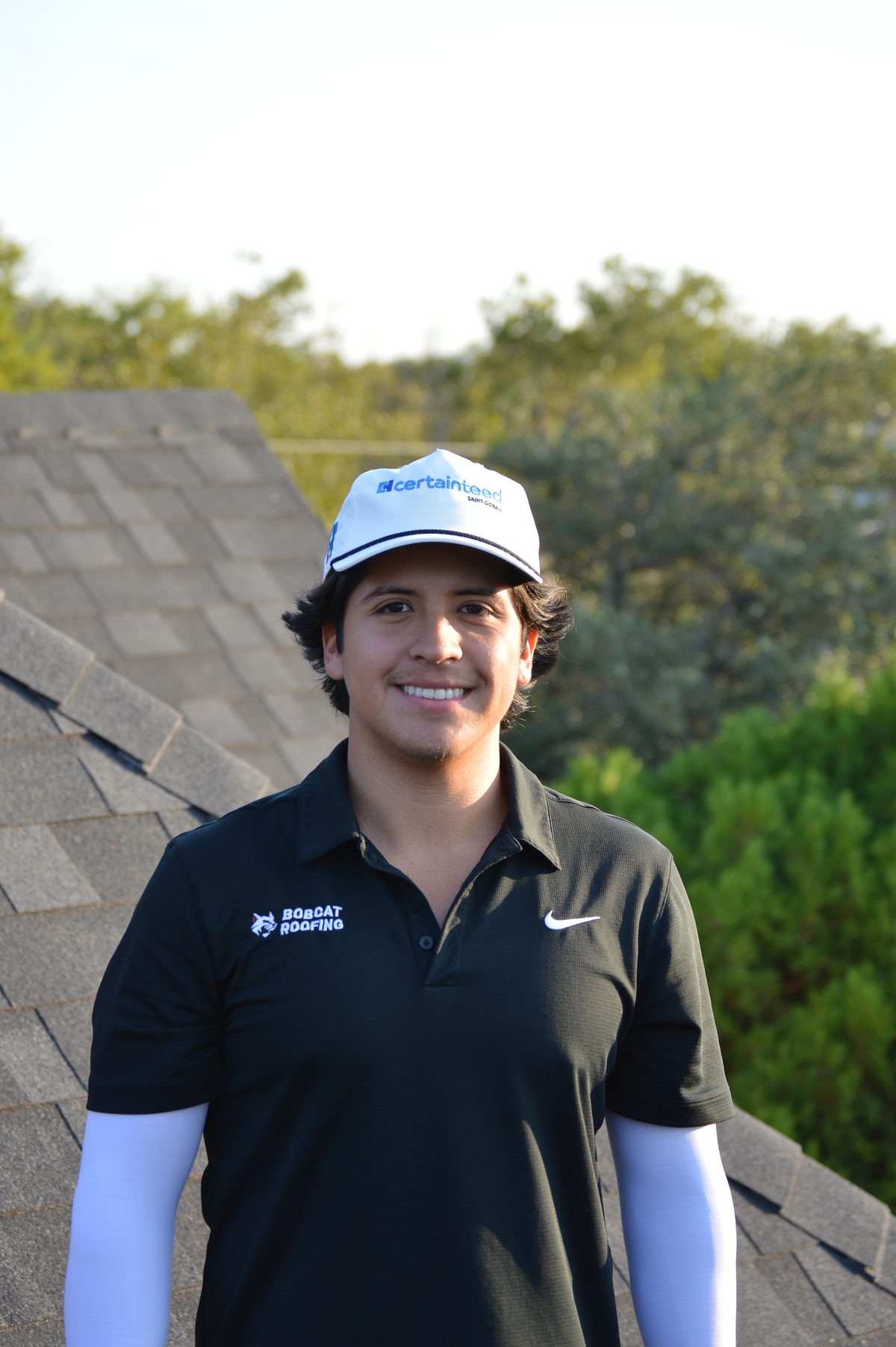 Jay, founder of Bobcat Roofing, standing on a customer's roof